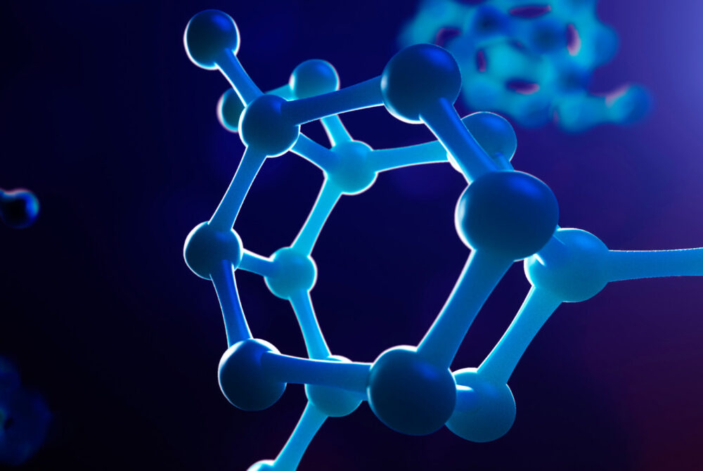 Plastic model of polymer chain against a blue background