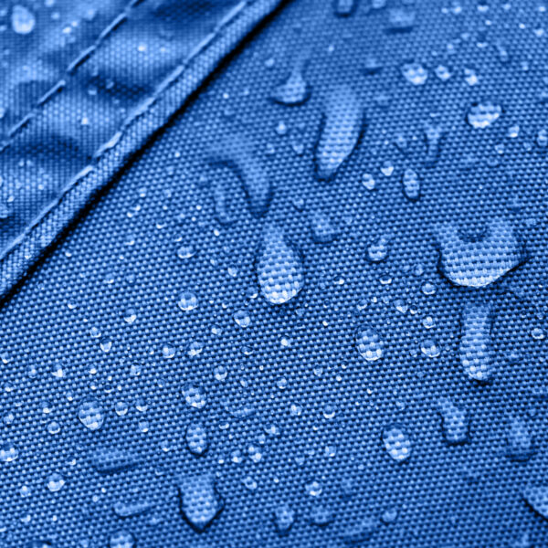 Dark blue rainproof tent sheet with morning rain drops