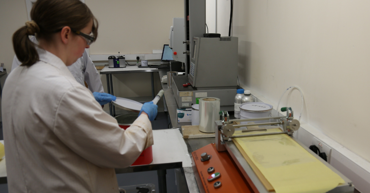 Lab Assistant working with draw down coater for testing