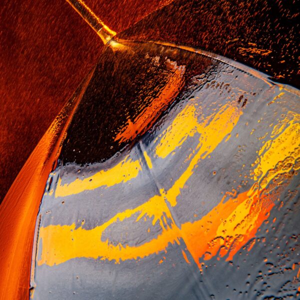 blue and orange umbrella with rain running down its surface