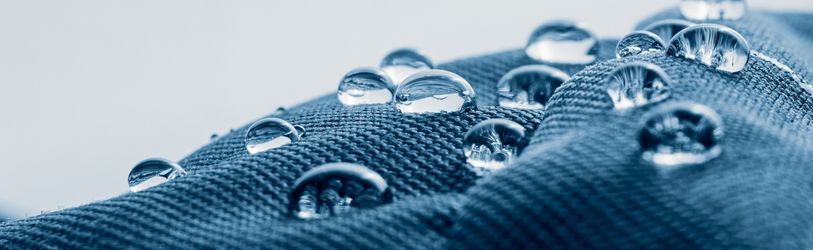 water droplets on a blue fabric.