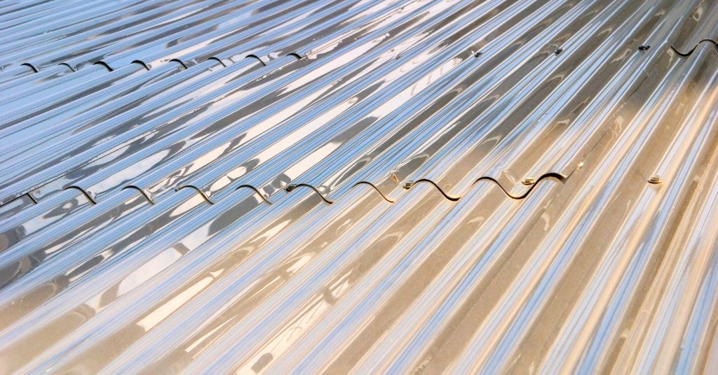 Shiny silver corrugated metal roof sheets after coating applications.
