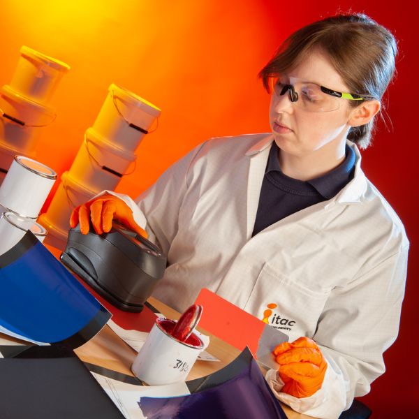 Female development chemist performing colour testing on coating product